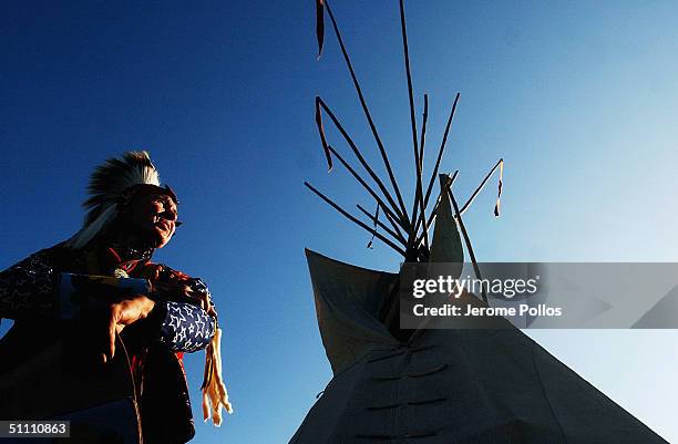 Howard Ball, a Cherokee tribal member from Liberty Lake, Wash. Tends to the final details of his regalia before the grand entry of the Julyamsh Pow...