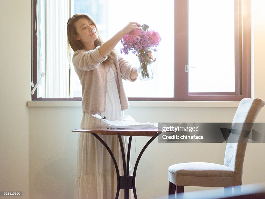 Japanese Woman arranging flowers