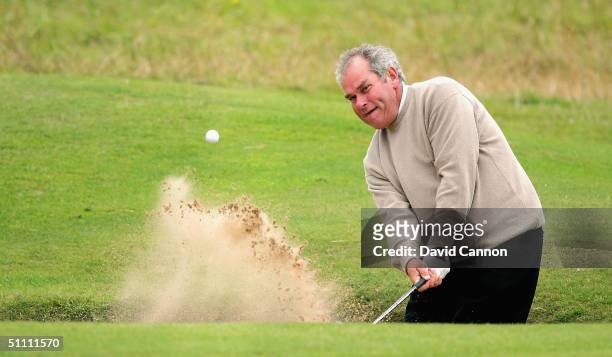 Russell of England plays his third shot from sand at the 18th hole on his way to one of the only sub par rounds of the day during the third round of...