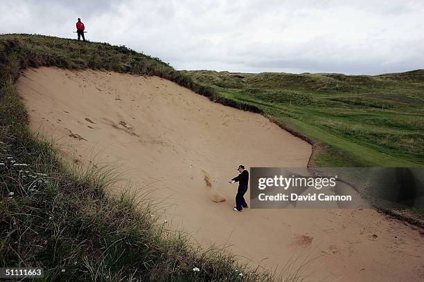 Tom Watson of the USA plays his second shot from the huge bunker 'Big Bertha' at the 17th hole during the third round of the Senior British Open on...