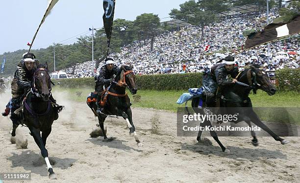 Samurai Riders dressed in full medieval armour take part in an equestrian contest during the Soma-Nomaoi festival on July 24, 2004 in Haramachi City,...