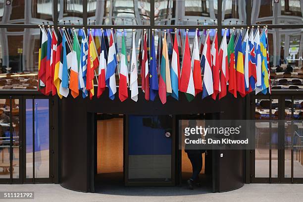 Flags of the European Union member states hang inside the Council of the European Union's Lex building on February 18, 2016 in Brussels, Belgium....