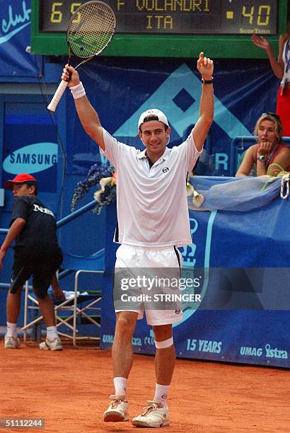 Filippo Volandri of Italy raises his arms after beating Carlos Moya of Spain in the semi-final match of Croatia Open ATP Tour in Umag 24 July, 2004....