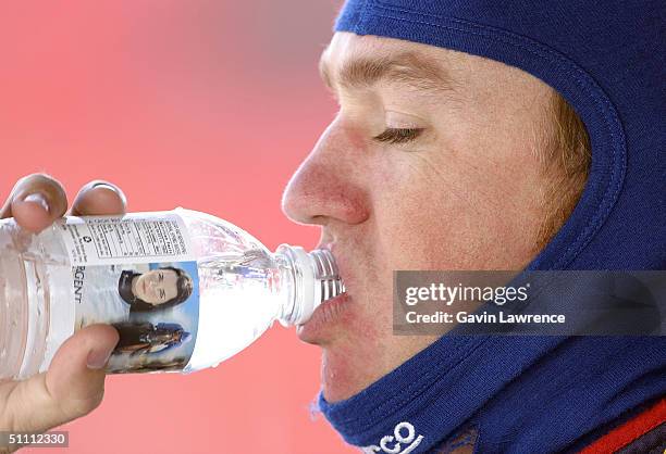 Buddy Rice, driver of the Rahal Letterman Racing Honda GForce, drinks from a bottle featuring Danica Patrick, the junior Formula Atlantic driver in...