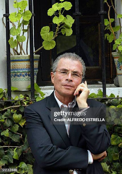 Juan Velazquez, lawyer of Mexican ex president Luis Echeverria Alvarez speaks on a mobile phone at former head of state's house 24 July 2004 in...