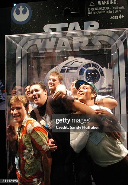 Group of boys pose while inside a large scaled replica action figure box during the Comic-Con Convention July 24, 2004 in San Diego, California....