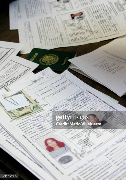 Applications with photographs and fees from Mexican citizens sit on a table to be processed for a ?Matricula Consular? card at the Wesley-McCabe...