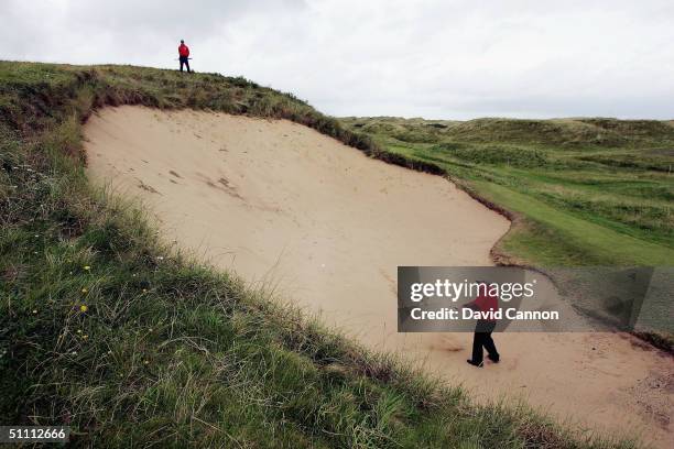 Graham Marsh of Australia plays his second shot from the huge bunker 'Bg Bertha' on the 17th hole during the third round of the Senior British Open...