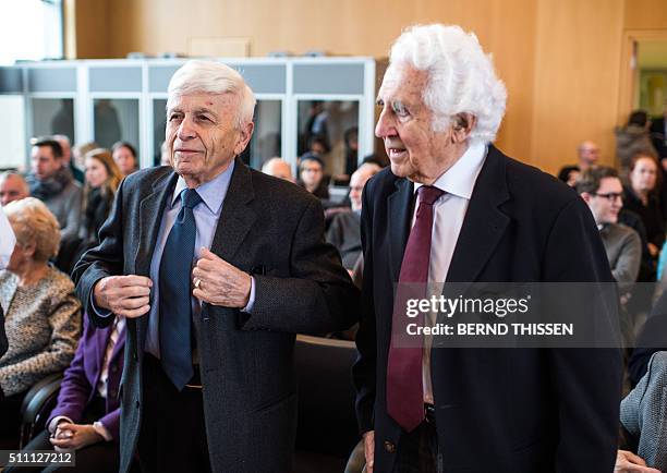 Holocaust survivors Max Eisen and William Glied arrive for a trial against a SS guard at the Auschwitz death camp on February 18, 2016 in Detmold,...
