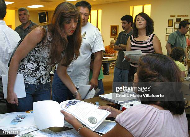 Norma Lunday , a Mexican citizen married to an American, listens while to applying for the ?Matricula Consular? card at the Wesley-McCabe United...