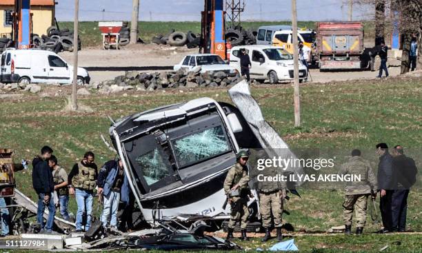 Turkish soldiers walk in front of a damaged army vehicle at Lice in Diyarbakir, southeastern Turkey, on February 18, 2016. At least six soldiers were...