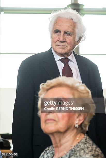 Holocaust survivor William Glied stands behind witness Irene Weiss in the courtroom after a trial against a SS guard at the Auschwitz death camp on...