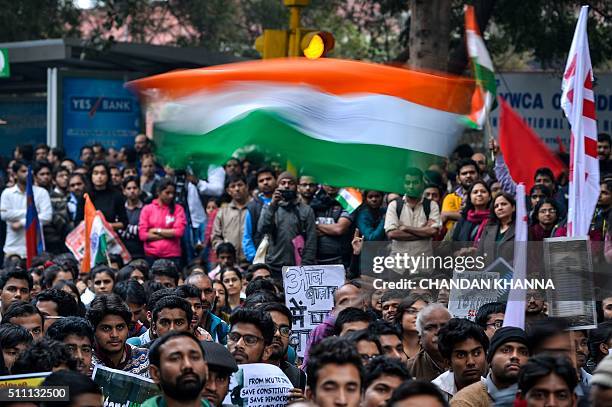 The Indian national flag is waved at a protest against the arrest of an Indian student for sedition in New Delhi on February 18, 2016. Thousands of...