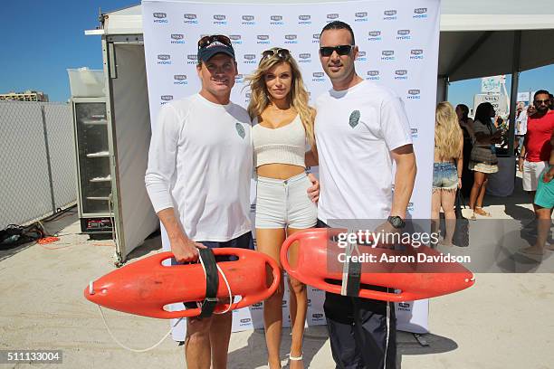 Model Samantha Hoopes and local life guards attend the Schick Hydro Barbershop at the Sports Illustrated Swimsuit Issue launch celebration on...