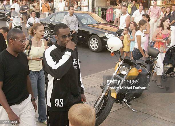 Star Sean "P.Diddy" Combs and Andre Harrell are pictured on the streets of St.Tropez with bodyguards on July 24, 2004 in France.