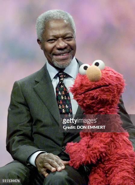 United Nations Secretary General Kofi Annan poses with the Sesame Street character Elmo after a taping of the show 06 December in New York. During...