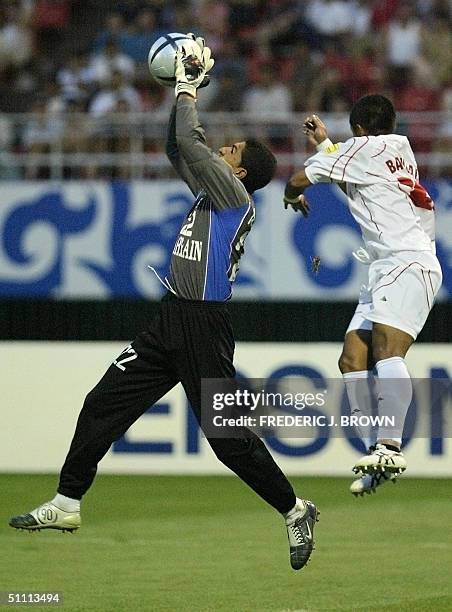 Bahrain goalkeeper Ali Saeed Abdulla collects a cross under pressure from Indonesia's Bambang Pamungkas ), 25 July 2004 in Jinan, during Asian Cup...