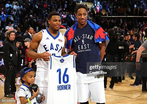 Kyle Lowry of the Toronto Raptors and the Eastern Conference and DeMar DeRozan of the Toronto Raptors and the Eastern Conference hold a jersey after...