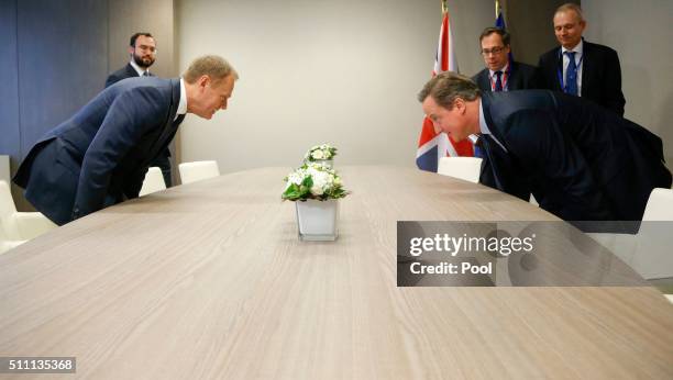 Britain's Prime Minister David Cameron and European Council President Donald Tusk take their seats for a bilateral meeting ahead of an EU summit...