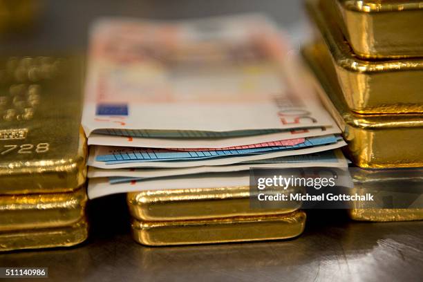 Muenchen, Germany Gold bars and money in the safe of Pro Aurum Gold trading house on February 16, 2016 in Muenchen, Germany.
