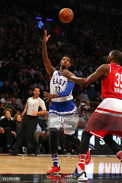 Paul George of the Indiana Pacers and the Eastern Conference goes to the basket against Kevin Durant of the Oklahoma City Thunder and the Western...