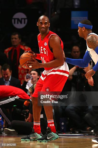 Kobe Bryant of the Los Angeles Lakers and the Western Conference handles the ball against Carmelo Anthony of the New York Knicks and the Eastern...