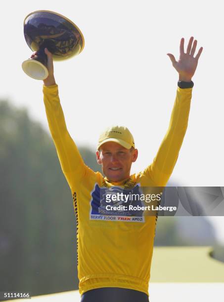 Lance Armstrong of the USA riding for the US Postal Service team presented by Berry Floor, celebrates on the podium after winning a sixth consecutive...