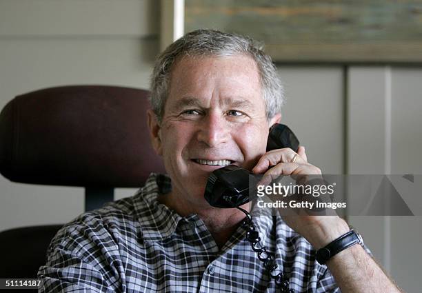 In this handout image provided by the White House, U.S. President George W. Bush congratulates cyclist Lance Armstrong on his record sixth Tour de...