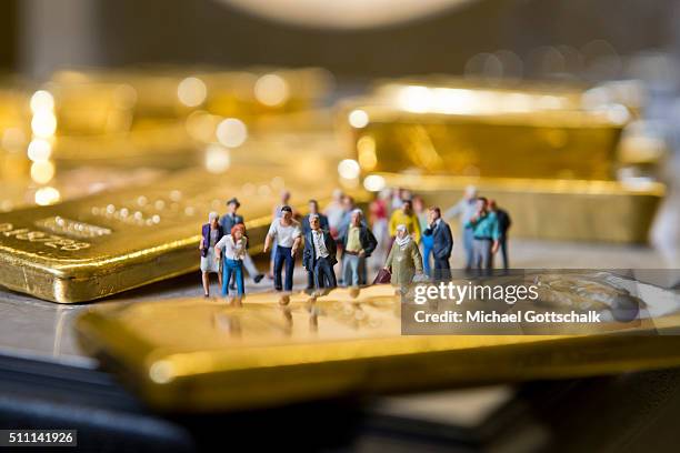 Muenchen, Germany Illustration shows people in front of gold bars on February 16, 2016 in Muenchen, Germany.