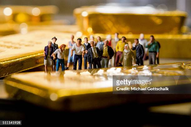 Muenchen, Germany Illustration shows people in front of gold bars on February 16, 2016 in Muenchen, Germany.