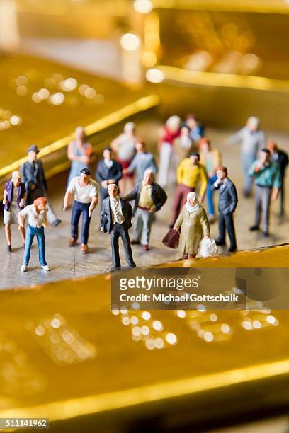 Muenchen, Germany Illustration shows people in front of gold bars on February 16, 2016 in Muenchen, Germany.