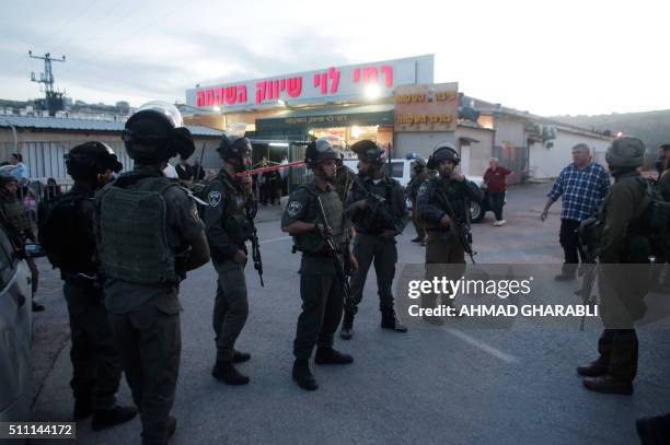 Israeli security forces stand guard outside the Rami Levi supermarket in Shaar Binyamin, near Ramallah in the occupied West Bank, after two...