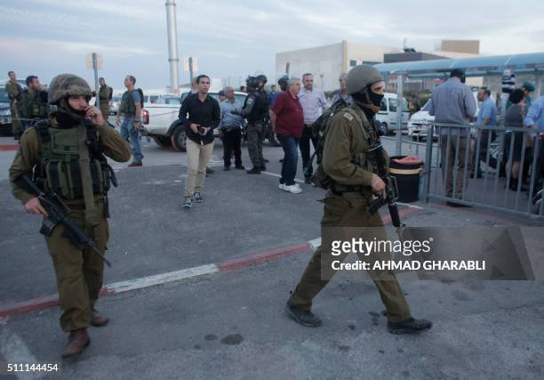 Israeli security forces stand guard outside the Rami Levi supermarket in Shaar Binyamin, near Ramallah in the occupied West Bank, after two...