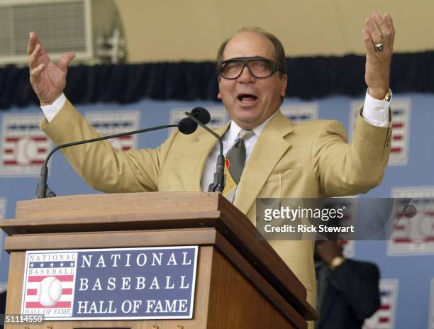 Johnny Bench, former Cinncinnatti Reds Hall of Fame catcher, does his "Harry Caray" imitation as he leads the crowd in "Take Me Out to the Ball Game"...