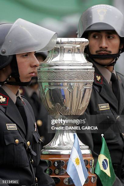 Peruvian policemen guard the Copa America's trophy displaying Argentine and Brazilian flags, 25 July 2004, during the Copa America 2004 final match...