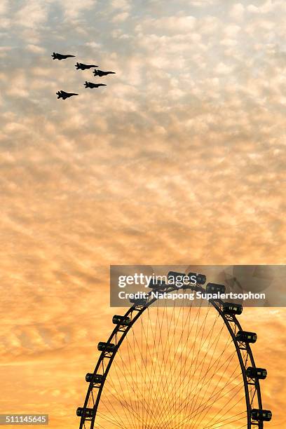 jet plane over singapore flyer - singapore-national-day stock pictures, royalty-free photos & images