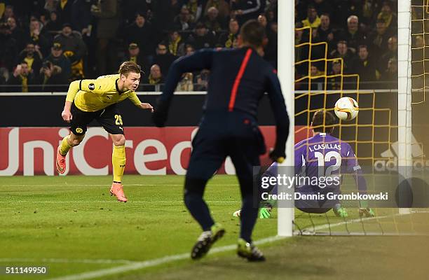 Lukasz Piszczek of Borussia Dortmund beats goalkeeper Iker Casillas of FC Porto to score their first goal during the UEFA Europa League round of 32...