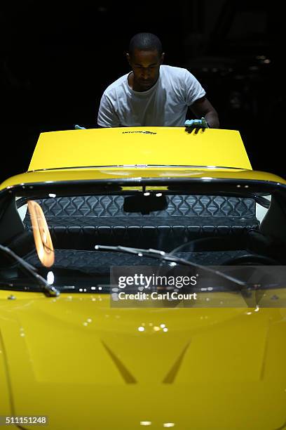 Member of staff closes the boot of a vintage car displayed at the Classic Car Show at ExCel on February 18, 2016 in London, England. The show...
