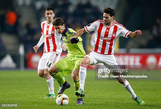 Filip Djuricic of Anderlecht and Alberto Botia of Olympiacos compete for the ball during the UEFA Europa League round of 32 first leg match between...