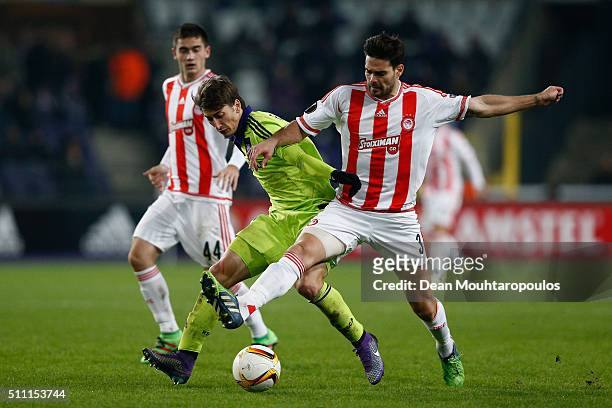Filip Djuricic of Anderlecht and Alberto Botia of Olympiacos compete for the ball during the UEFA Europa League round of 32 first leg match between...