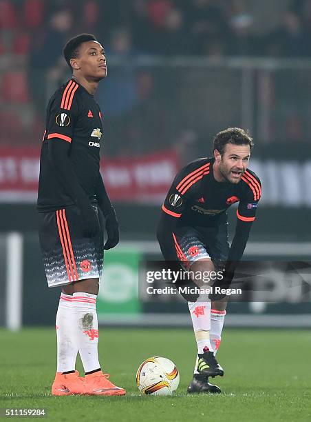 Anthony Martial and Juan Mata of Manchester United react after Midtjylland's second goal during the UEFA Europa League round of 32 first leg match...