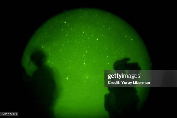 Soldiers from the 2-87 Infantry unit stand guard at night April 16, 2004 near the town of Ghazni, Afghanistan. The city is populated by 300,000...