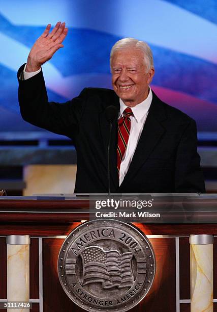 Former U.S. President Jimmy Carter waves to the audience after speaking on opening night of the Democratic National Convention July 26, 2004 at the...