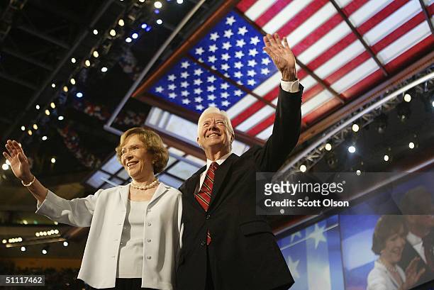 Former U.S. President Jimmy Carter and his wife Rosalynn wave to the audience during the Democratic National Convention at the FleetCenter July 26,...