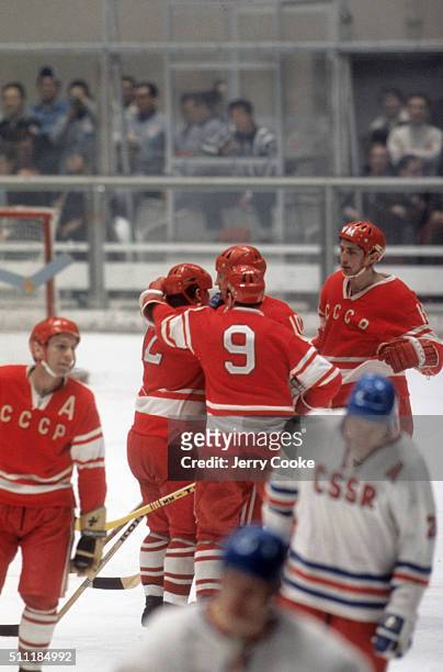 Winter Olympics: Soviet Union players Yevgeny Mishakov , Alexander Maltsev , Yuri Blinov , and Alexander Yakushev victorious on ice during game vs...