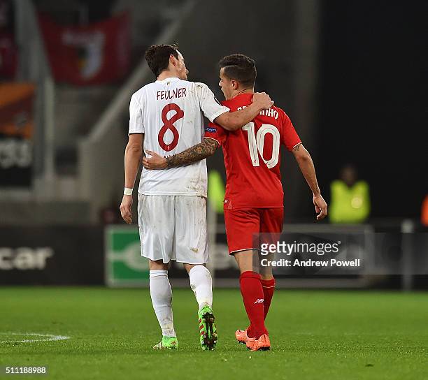 Philippe Coutinho of Liverpool embraces Markus Feulner of Augsburg during the UEFA Europa League Round of 32: First Leg match between FC Augsburg and...