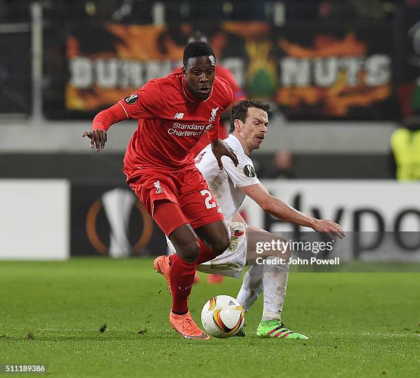 Divock Origi of Liverpool competes with Markus Feulner of Augsburg during the UEFA Europa League Round of 32: First Leg match between FC Augsburg and...