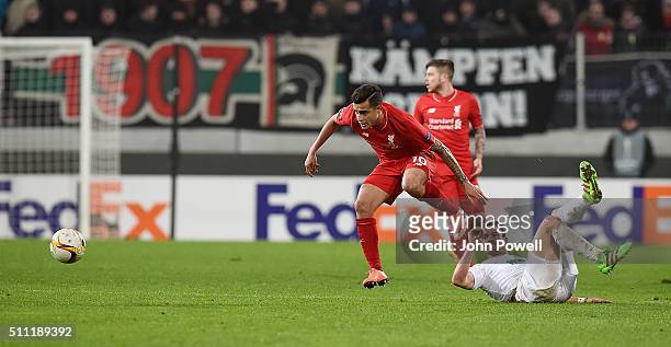 Philippe Coutinho of Liverpool competes with Markus Feulner of Augsburg during the UEFA Europa League Round of 32: First Leg match between FC...