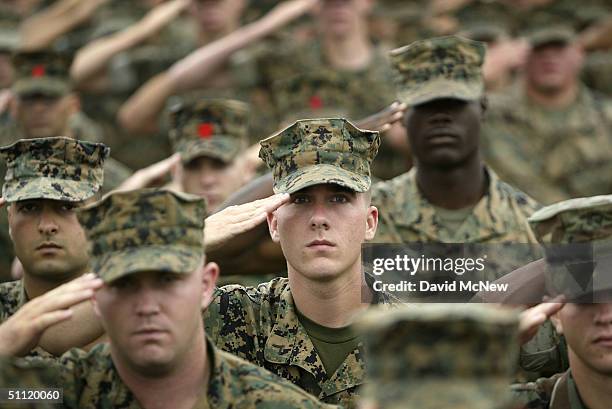 Marines and sailors of the 1MEF salute the flag prior to the arrival of U.S. Vice President Dick Cheney during a campaign stop July 27, 2004 in Camp...