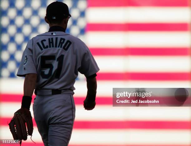 Ichiro Suzuki of the Seattle Mariners walks to right field in the first inning against the Oakland Athletics at a MLB game at the Network Associates...